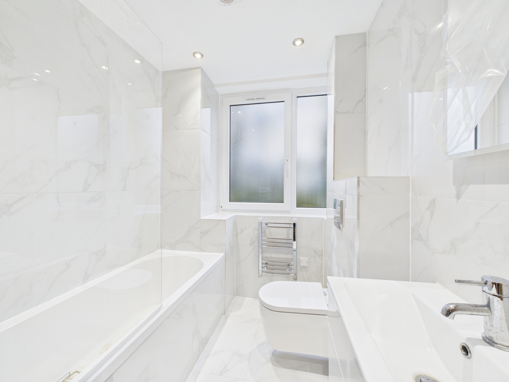 “Modern bathroom with bath and shower in Tricorn House apartment Stroud Gloucestershire”